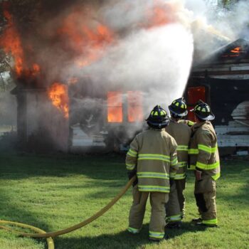 Firefighters battling a house fire | ATI Restoration