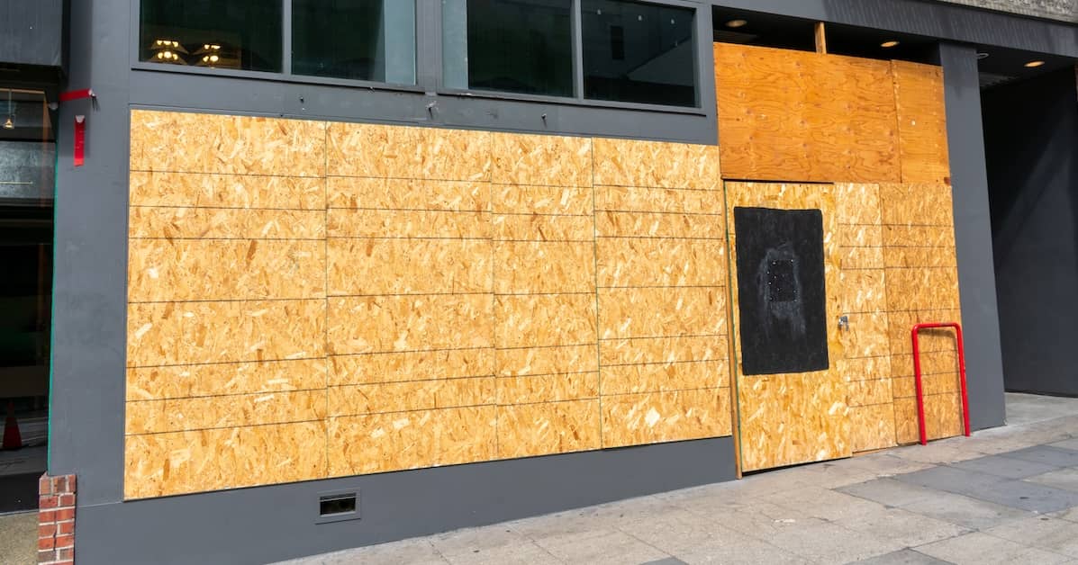 Exterior of a property boarded up after a disaster | ATI Restoration