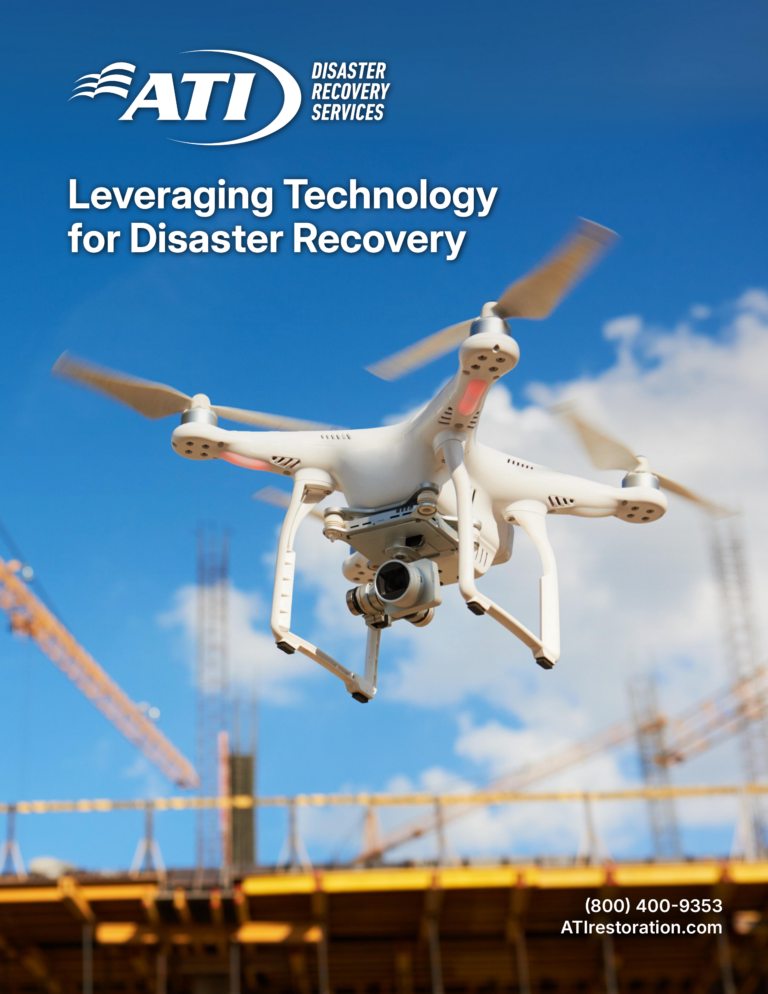 Drone with camera flying over a construction site; ATI Disaster Recovery Services logo.