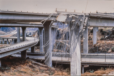 Collapsed section of highway overpass after earthquake.