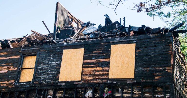 Property with boarded-up windows after a fire | ATI Restoration